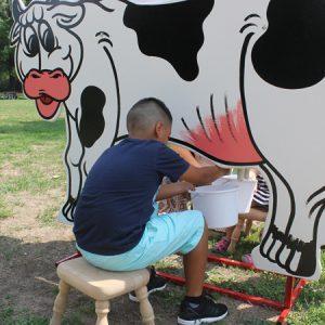 Close up of Boy using Cow Milking Game
